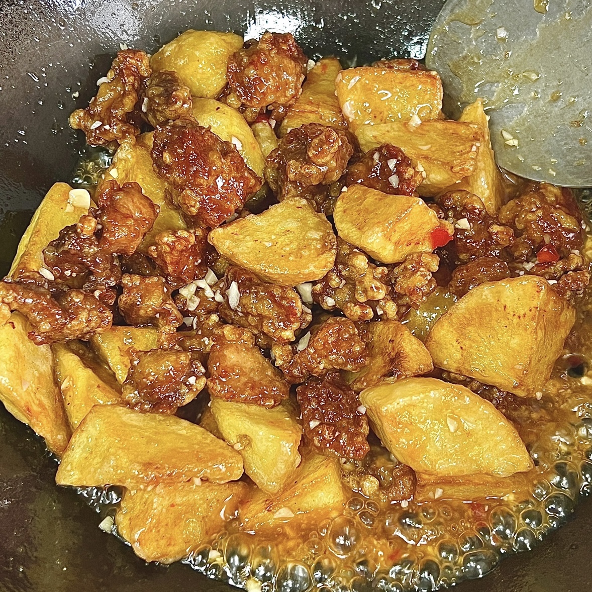 Tossing pork with sauce and serving